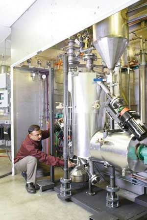 Nikhil Patel, research scientist at the EERC, works on a bench-scale thermally integrated biomass gasifier.