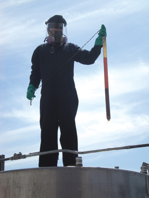 A worker samples the product from the top of the tank. PHOTO: BIODIESEL INDUSTRIES