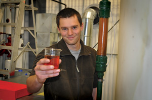 BIODIESEL CHEERS: Mark Uher is a lab technician for CARES' biodiesel facility at University of Guelph's Ridgetown Campus in Ontario, Canada. The plant can produce 1 MMly, or 256,000 gallons, of biodiesel per year. photo: Liz Meidlinger, UNIVERSITY OF