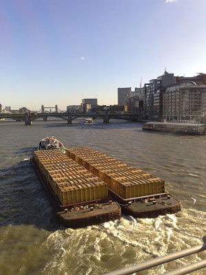 Barges laden with rubbish-filled containers destined for landfills elsewhere are a common sight on the Thames River in London./PHOTO: MATT SEPPINGS
