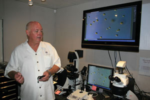 Kertz demonstrates the microscopy station in the state-of-the-art lab he created to discover and analyze varieties of algae for biomass production.