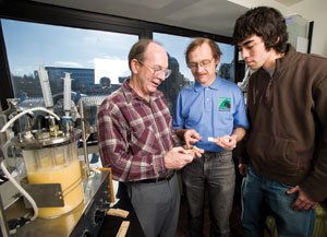 Weimer, center, discusses tests of a new biobased glue with chemist Chuck Frihart, left, and technician Brice Dally of the USDA Forest Service's Forest Products Laboratory.