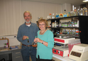 Leschine, right, and Warnick hold cultures of the Q microbe in the lab at the University of Massachusetts in Amherst where Q was isolated and its novel properties discovered.