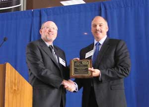 White Energy President and CEO Kevin Kuykendall, right, accepts the Project of the Year Award from Russell Smith of the Texas Renewable Energy Industries Association.