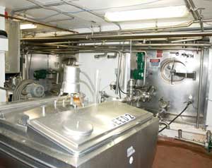 Van Groll has adapted cheese-making equipment. The small square bulk milk tank in the foreground is used for yeast propagation and the milk silo in back is used for fermentation.