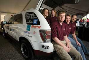 Mississippi State University engineering students pose for a photo in the back of their vehicle before the start of the Challenge X competition. Pictured in front, left to right, are team leader David Oglesby, Michal Trcalek and Matthew Young; in bac