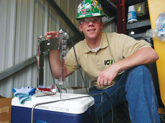 Adam Anderson, ICM product manager, prepares a monometer for taking a vapor flow reading. 