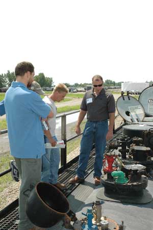 Students examine the many styles of top valve arrangements atop the GATX TankTrainer tank car.