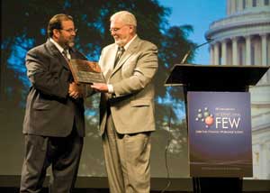 At the 24th annual FEW, Bryan, right, chief executive officer of BBI International, presented RFA President Bob Dinneen with a plaque recognizing his 20 years of service to the renewable fuels industry./PHOTO: BBI INTERNATIONAL