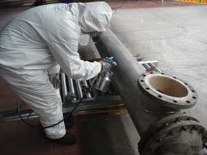 A worker applies a coat of Nansulate thermal paint to a pipe at the Grupo Modelo Brewery in Mexico. Photo: Nansulate